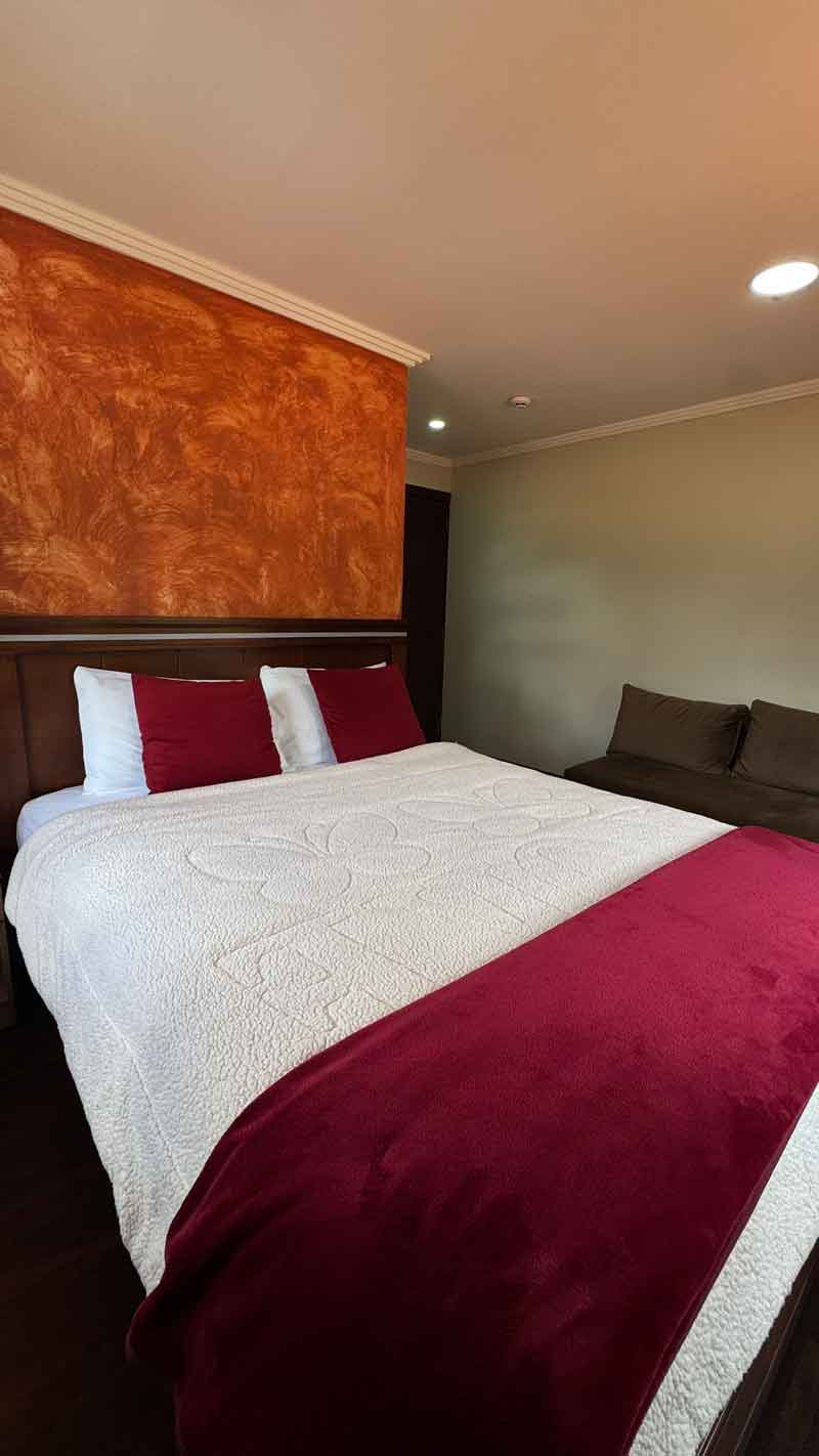 Cama matrimonial con detalles en rojo